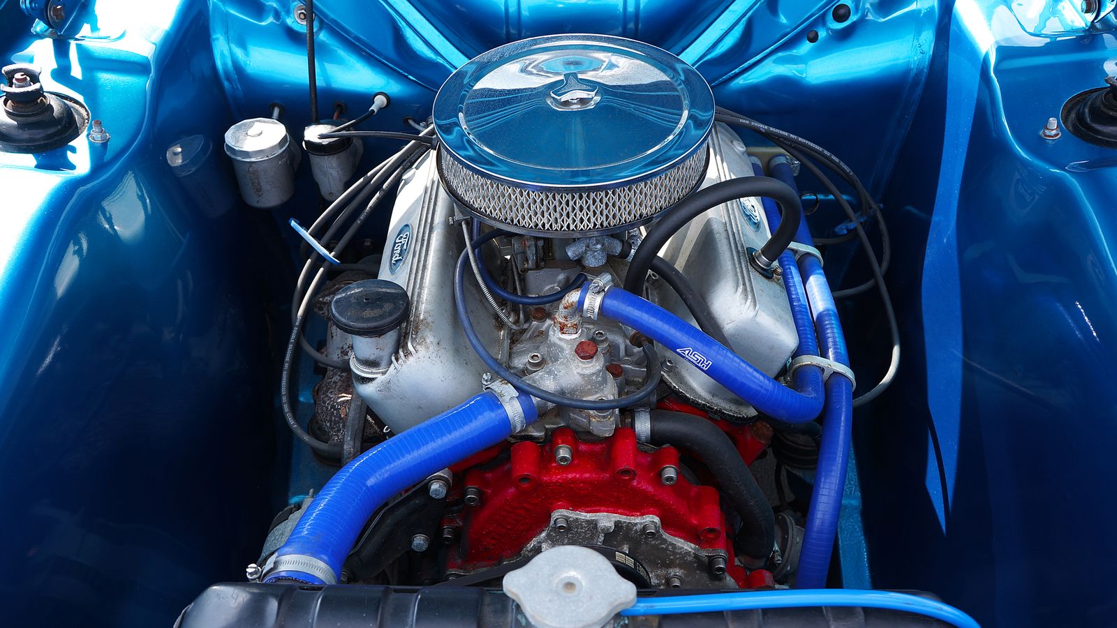 Engine bay with air cleaner, hoses and parts